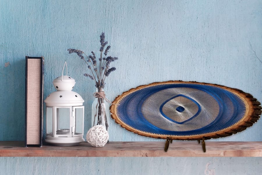 Blue Evil Eye symbolic handmade artwork on natural wood by Asja
