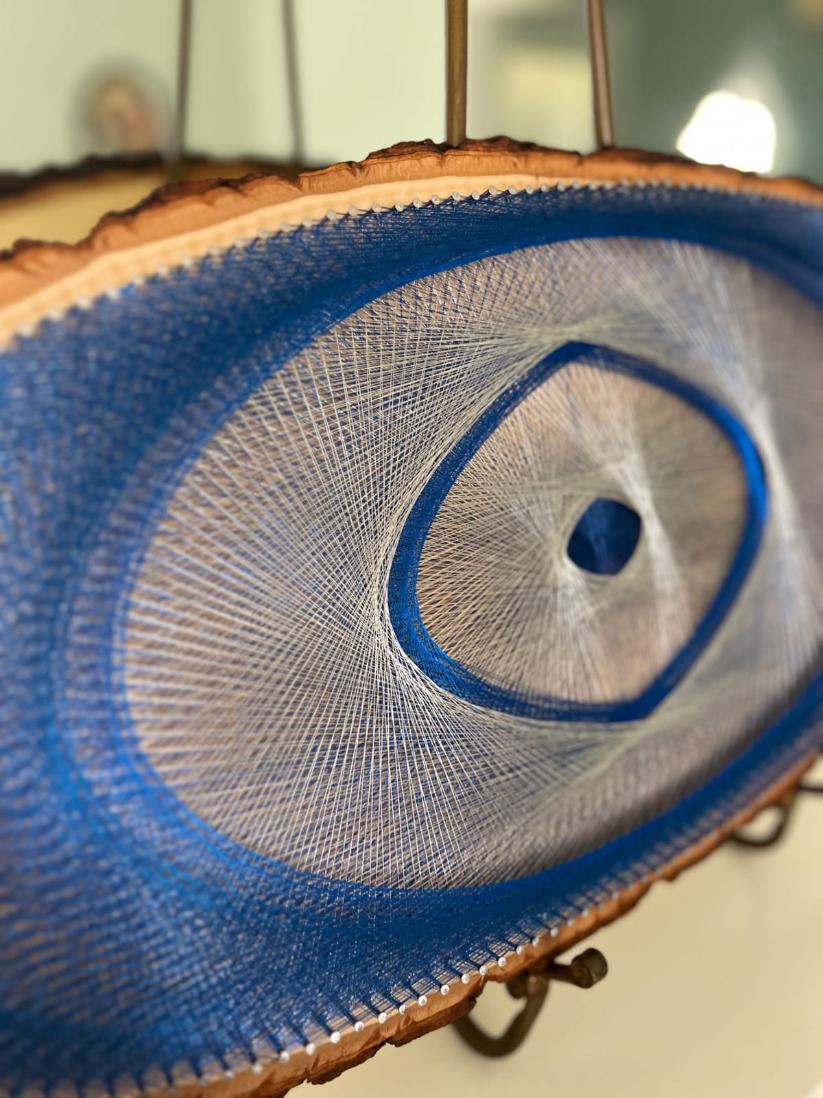 Blue Evil Eye String Art on Wood Slice, detail view 5 — handmade string art by Asja